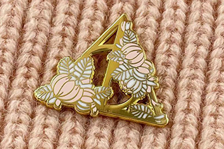 1, The process is similar to that of an enamelled badge: a drawing is designed, a steel mold is carved, copper is pressed into shape with a mold, and the concave area is filled with an enamelled material.
2, It is roasted at high temperature and polished by hand until the surface is shiny.
3, The surface of the hard enamel badge can also use screen printing to apply a variety of colors, to meet the requirements of the guests without changing the design of important elements, such as the logo, the name, etc.
4, Moreover, since fake enamel badges are cheaper than real enamel badges and work quite well, they have gradually replaced real enamel badges.
5, The difference between imitation hard enamel badge and paint badge: imitation enamel badge surface pattern and text in the same plane, hand touch there is a slight convex feeling, micro and paint badge has this is also concave and convex, hand touch can feel the obvious uneven, this is also the main method of difference between imitation enamel badge and paint badge.