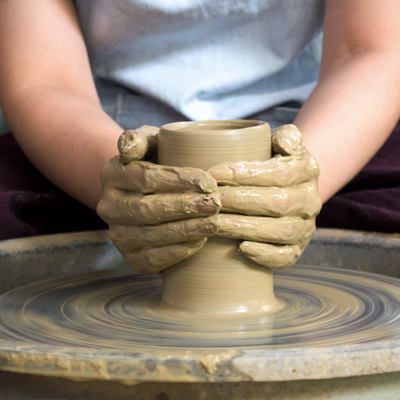 close-up-of-female-potters-hands-making-bowl-698034562-5a73678230371300372f59e4