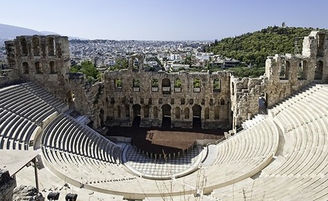 The Odeon was built in 161 AD by the Athenian magnate Herodes Atticus in memory of his wife, Aspasia Annia Regilla. It was originally a steep-sloped theater with a three-story stone front wall and a wooden roof made of expensive, cedar of Lebanon timber. It was used as a venue for music concerts with a capacity of 5,000.